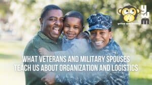 Family of three, hugging and smiling. Father is in a green shirt, son is in blue shirt, and Navy Veteran and Military Spouse are in camouflage uniform.